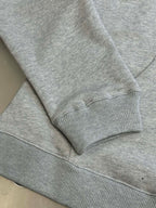 Light gray sweatshirt cuff with ribbed hem and sleeve seam