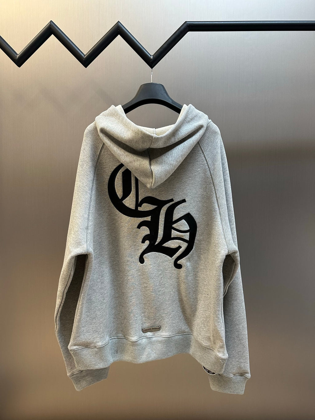 Light gray hooded sweatshirt with large black graphic on back