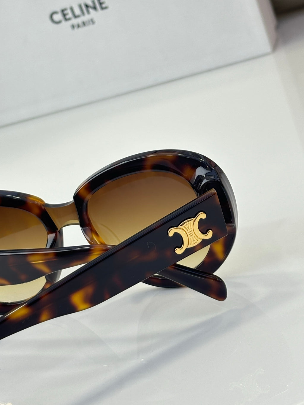 Celine sunglasses temple detail with gold logo and tortoiseshell finish