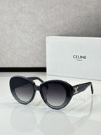 Celine round sunglasses with dark lenses, black frames, gold temple emblem