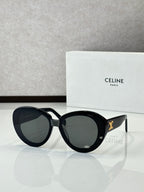 Celine round sunglasses with dark lenses and black frames, gold logo on temples