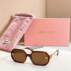 MiuMiu sunglasses with tortoiseshell oversized frames, amber lenses, and gold logo detailing