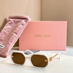 MiuMiu sunglasses with white oversized frames, dark lenses, and gold logo detailing