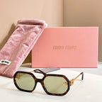 MiuMiu sunglasses with tortoiseshell oversized frames, green-tinted lenses, and gold logo detailing