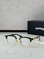 Black and gold full-rim metal eyeglasses with clear lenses