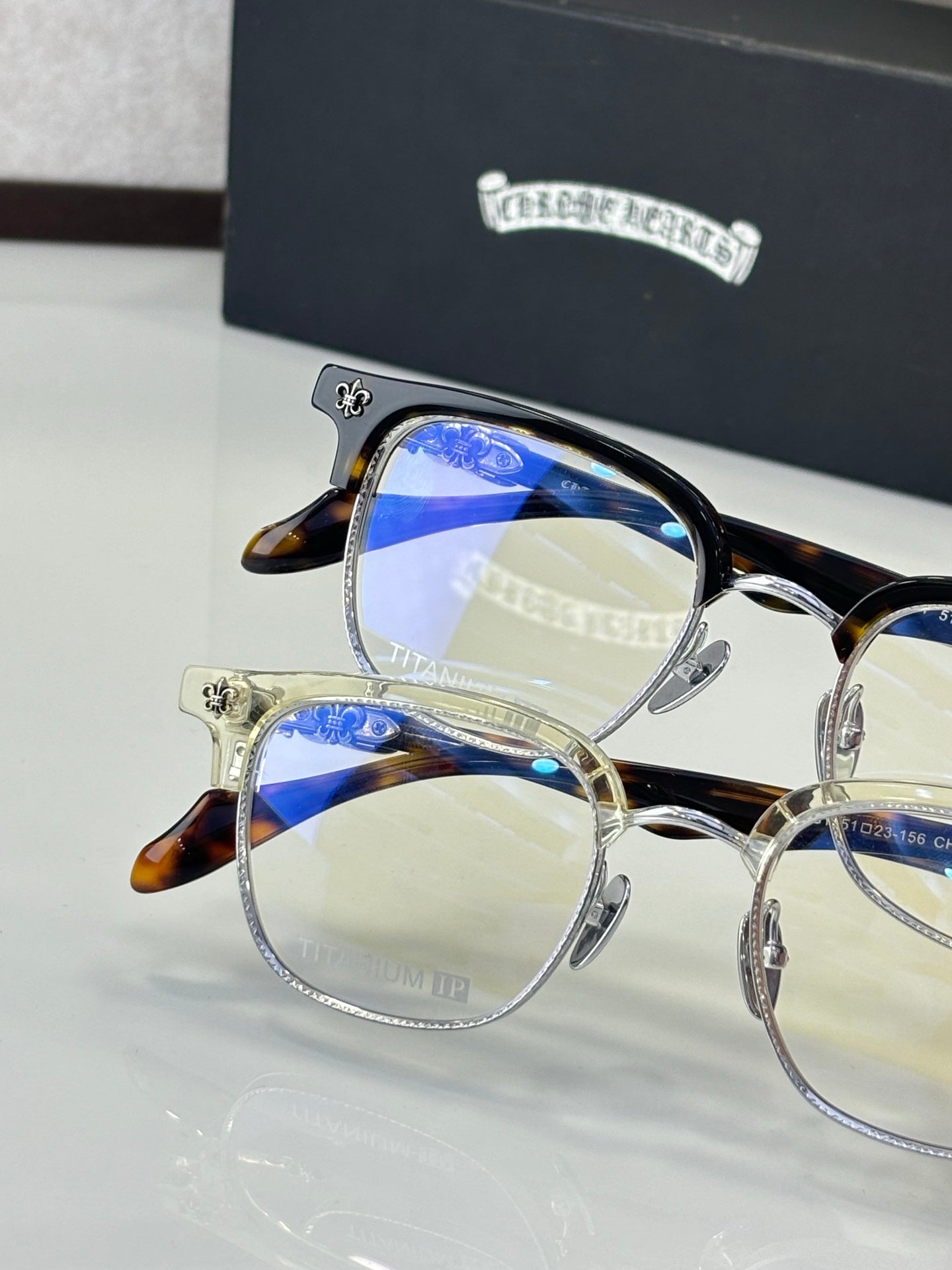 Tortoise and gold full-rim eyeglasses with clear lenses, close-up