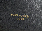 Louis Vuitton Paris embossed text on black textured leather