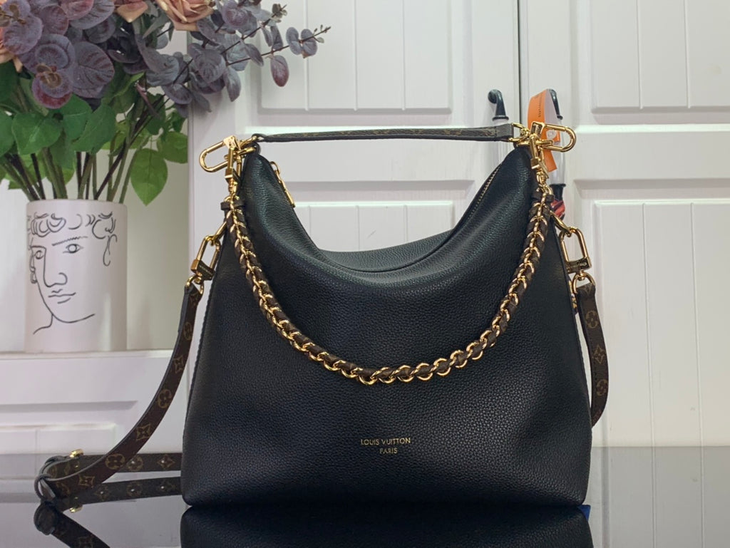 Black leather shoulder bag with gold chain strap and top handles