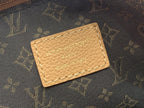 Louis Vuitton monogram bag interior label on tan leather patch.