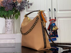 Louis Vuitton hobo shoulder bag with tan leather front, gold chain handle, and patterned strap.