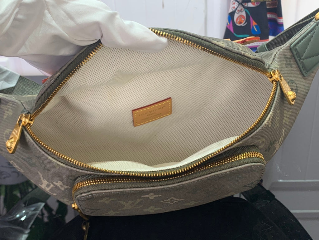 Louis Vuitton monogram bag interior with central pocket and gold zipper trim