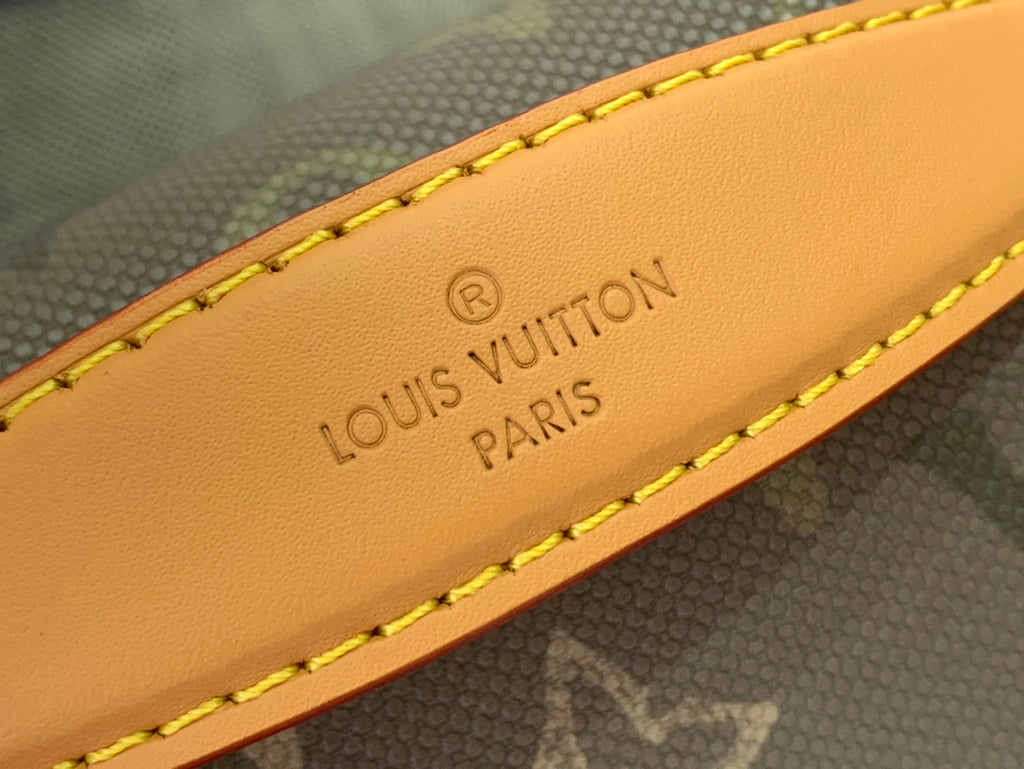 Louis Vuitton leather strap with tan panel and stitched logo text