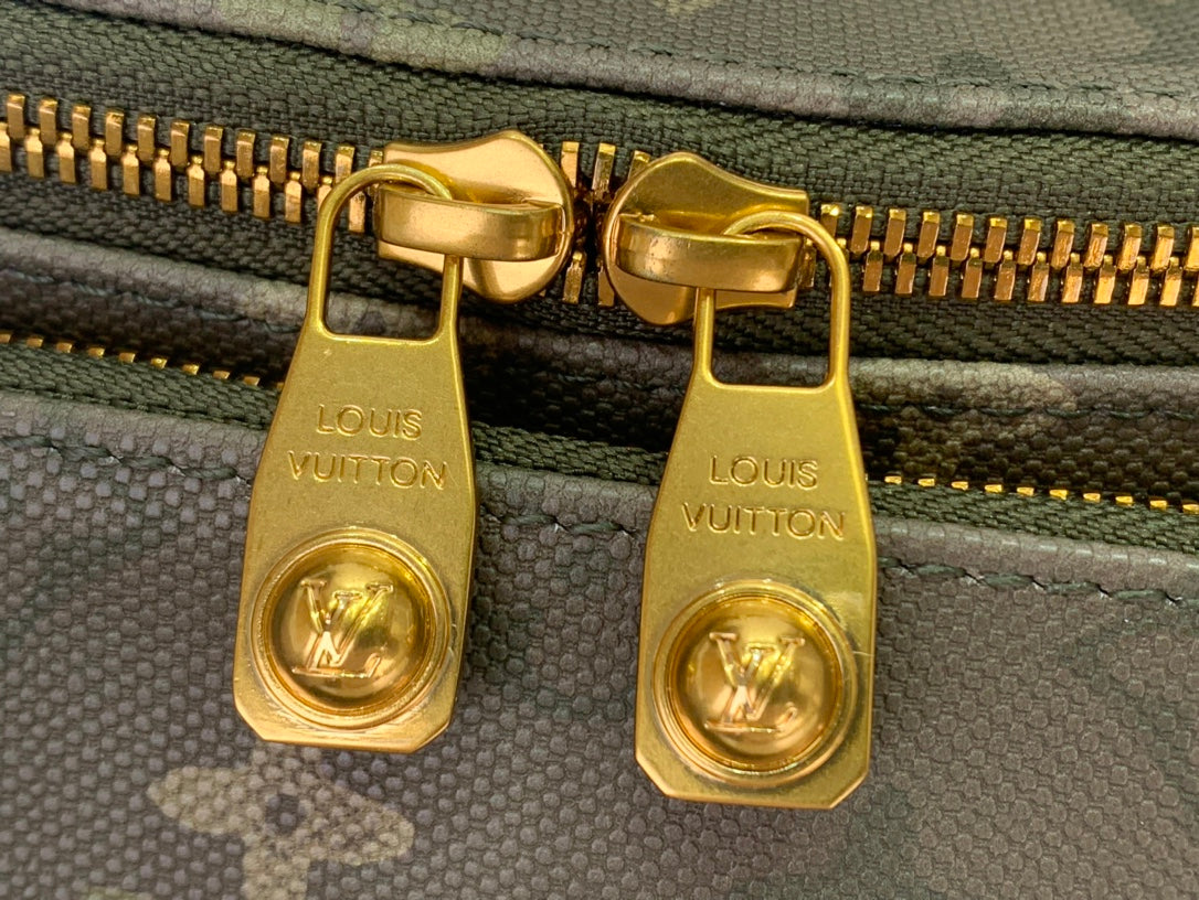 Louis Vuitton zipper sliders with gold hardware and embossed brand marks