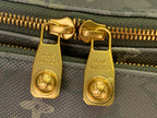 Louis Vuitton belt bag zipper hardware close-up with gold pull tags