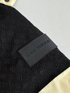 Black monogram-embossed fabric with Louis Vuitton logo patch