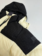 Black puffer jacket with cream hood lining and contrast panels