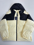 Two-tone hooded puffer jacket, cream body with black sleeves and drawstring hood