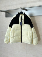 Two-tone puffer jacket with hood, black and cream panels, front zip closure