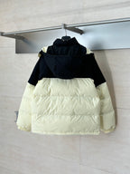 Two-tone hooded puffer jacket with front zip, black top and cream lower panels