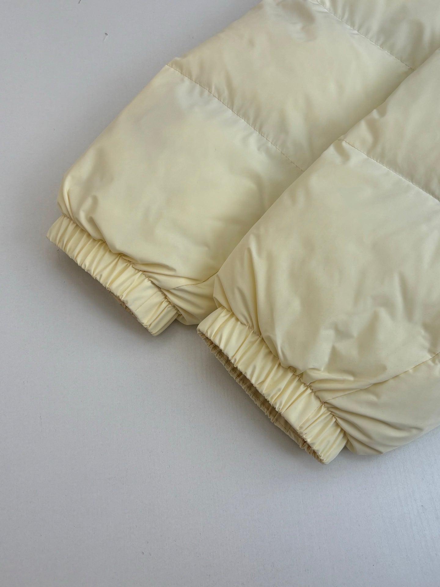 Cream puffer sleeves with gathered elastic cuffs