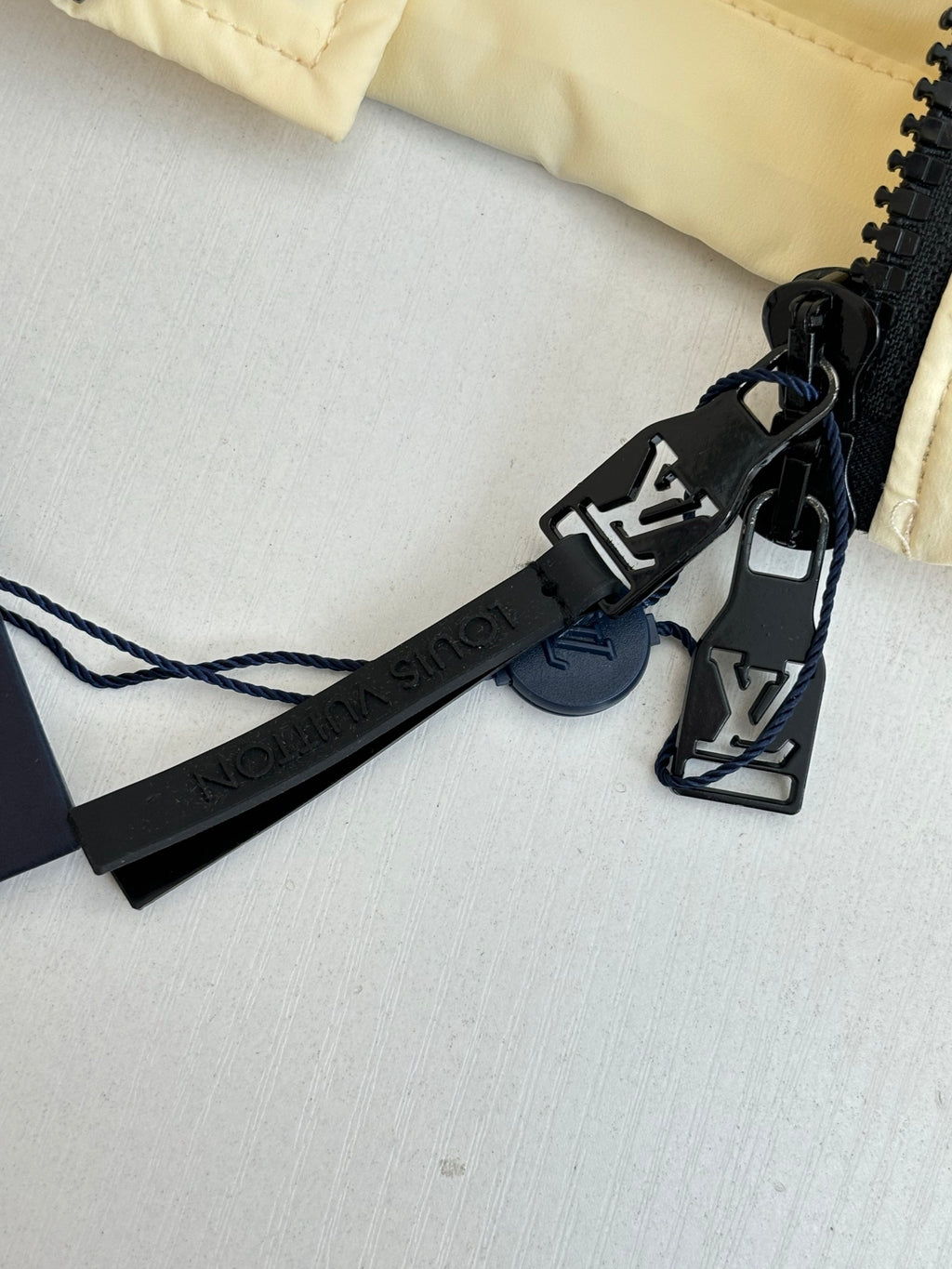 Louis Vuitton logo clip and black strap on long clothing piece