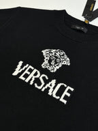 Black Versace knit sweater with crest and VERSACE wordmark