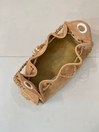 Tan quilted suede handbag interior view with gold-tone chain and top hardware rings.