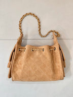 Tan quilted suede mini handbag with gold-tone chain handle and structured top openings.
