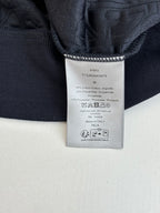 Dark long garment with woven care label