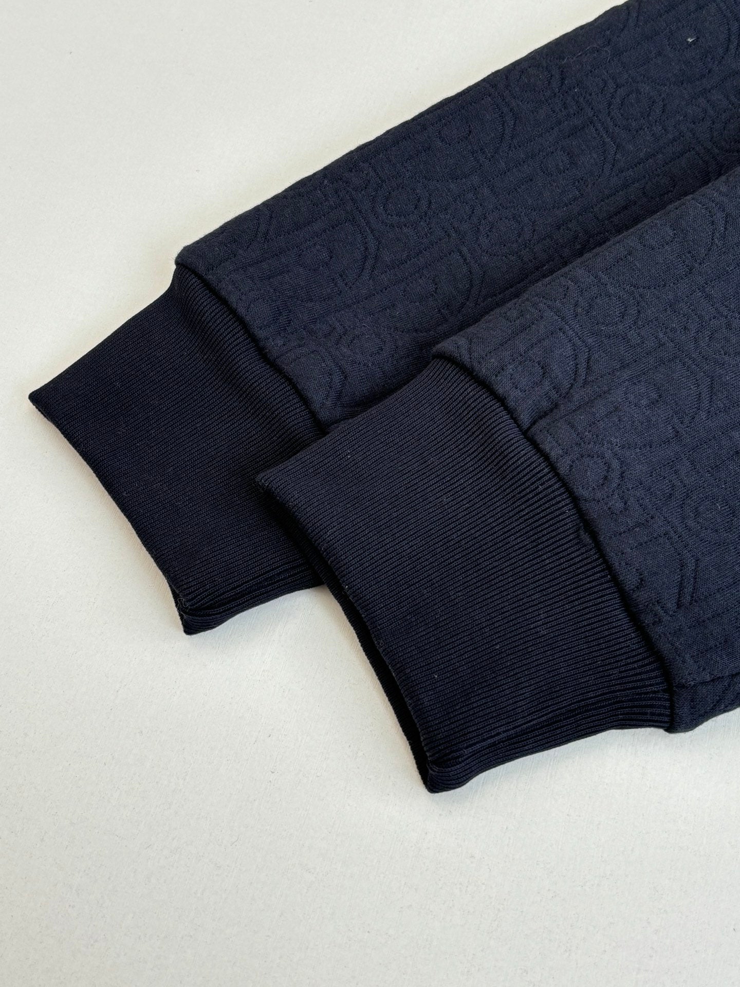 Dior navy long pants, ribbed cuffs and textured monogram pattern