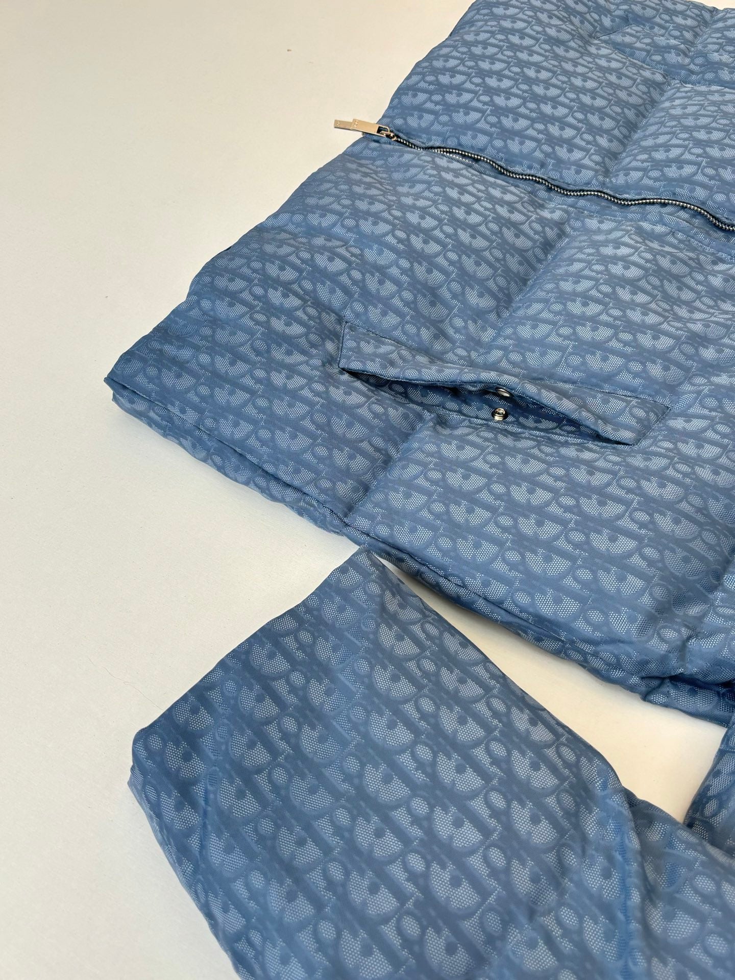 Blue Dior puffer jacket showing quilted layers and folded collar area