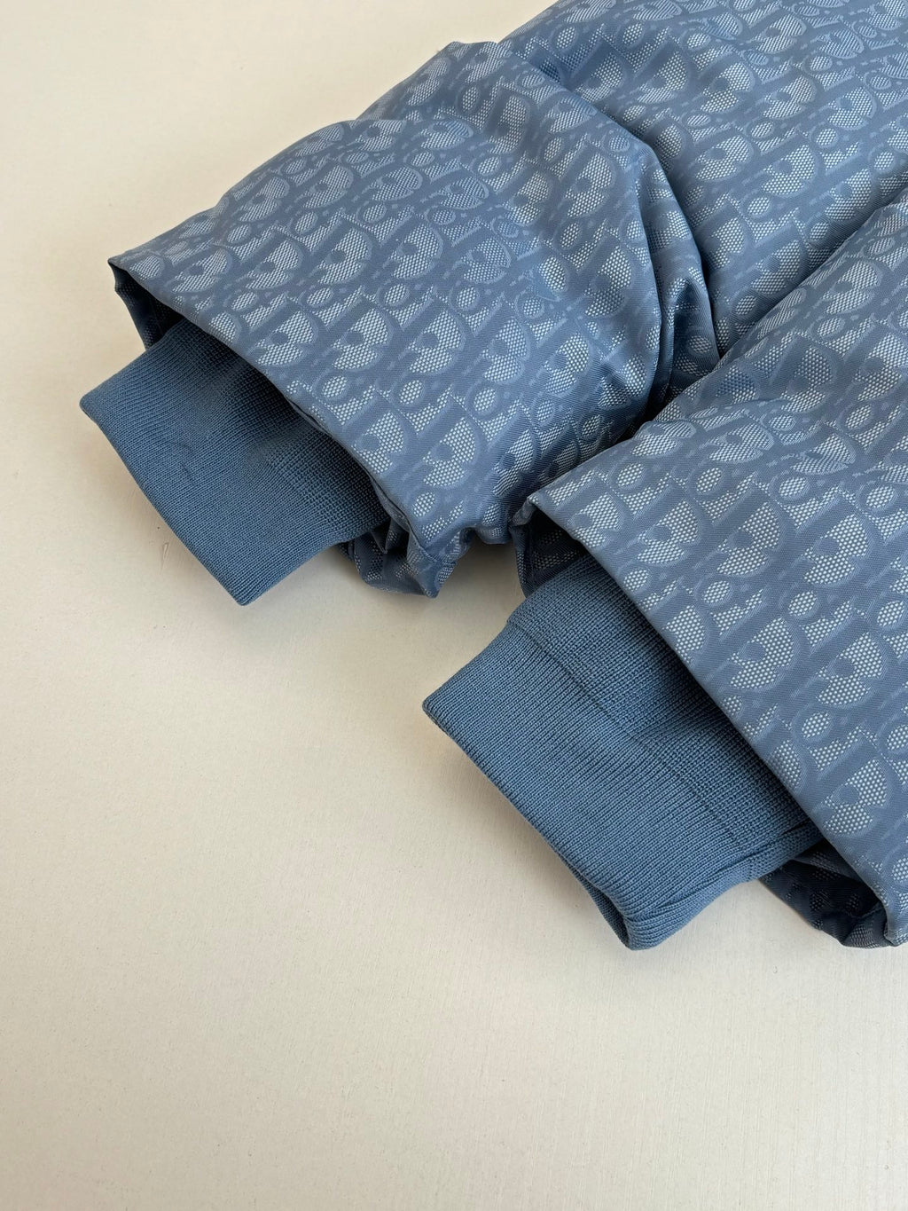 Blue long-sleeve shirt with allover Dior pattern and ribbed cuffs, folded