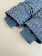 Blue long-sleeve shirt with allover Dior pattern and ribbed cuffs, folded