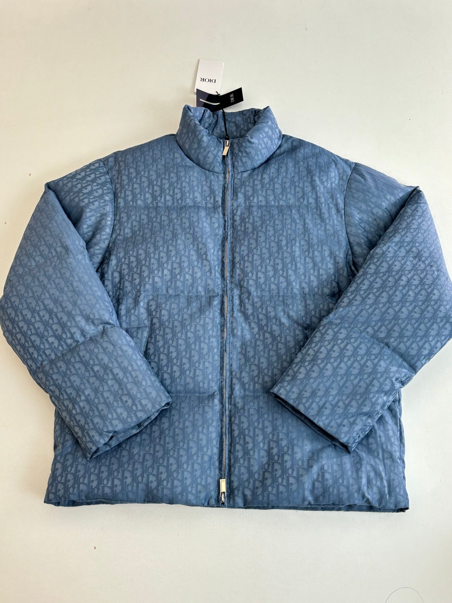 Blue Dior puffer jacket front view with stand collar and centered zipper