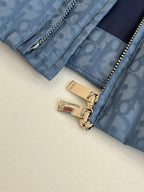 Blue Dior puffer jacket close-up of gold zippers and logo hardware