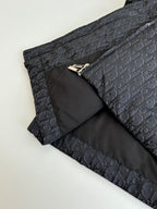 Long quilted Dior jacket with zipper and dark monogram shell, folded with inner lining.
