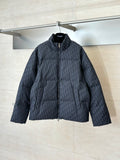 Long quilted Dior jacket with full-zip front, standing collar, dark textured fabric.