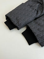 Dior long garment in dark patterned fabric, folded with long sleeves