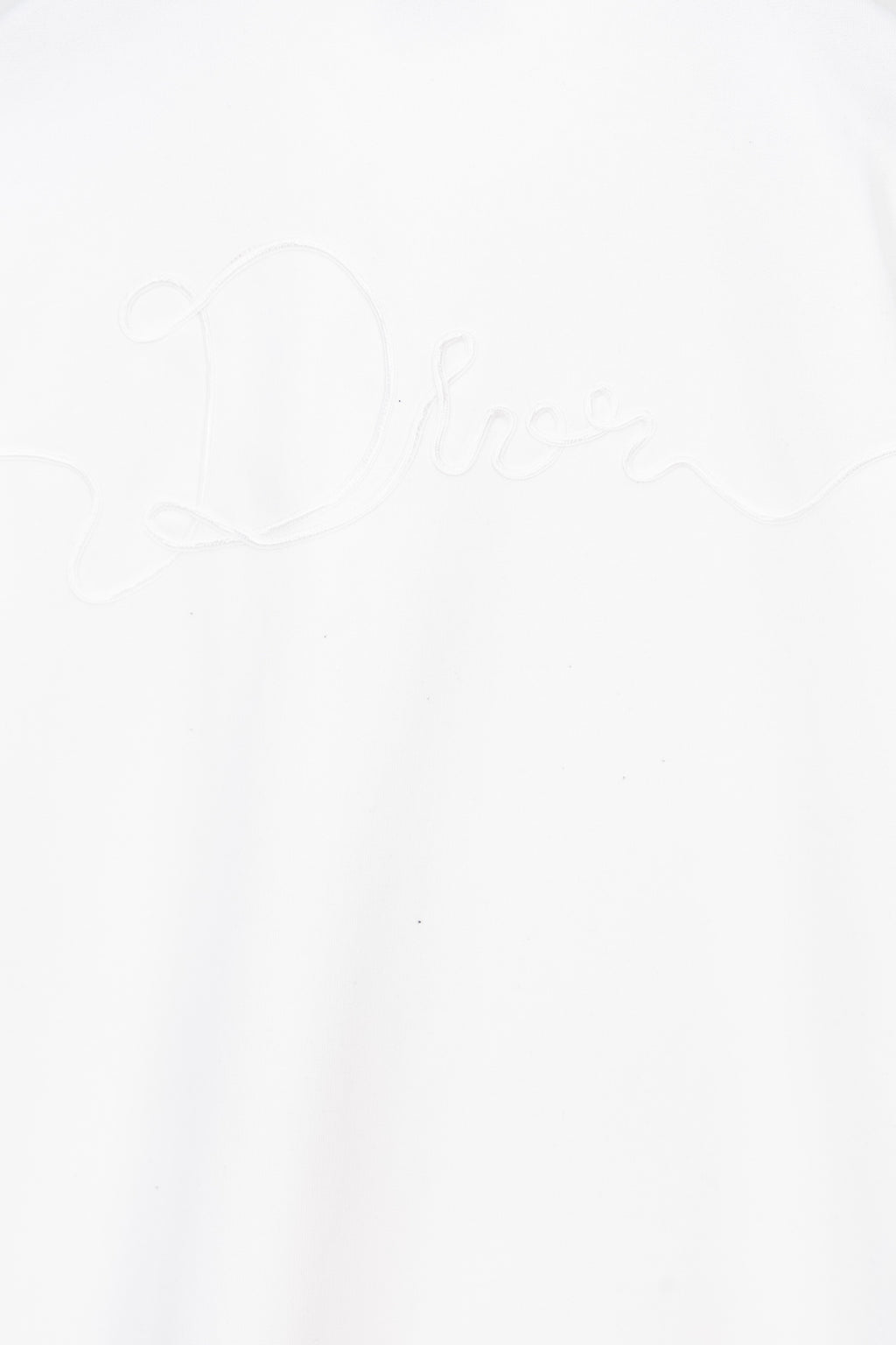 White sweatshirt front with subtle Dior signature embroidery near center