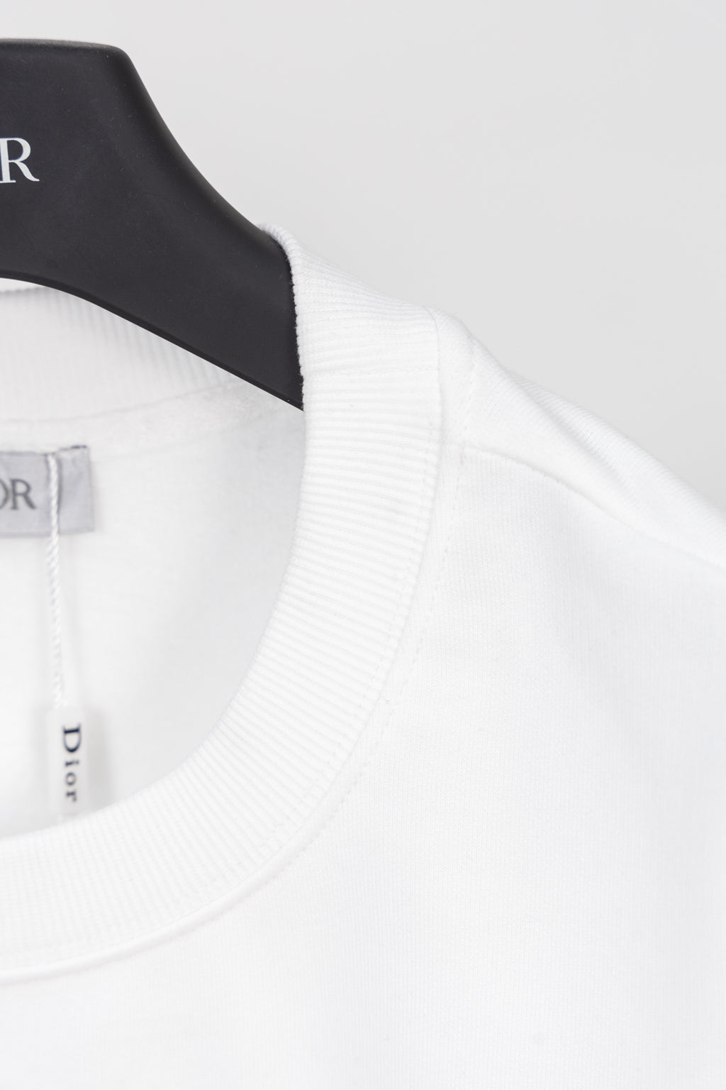 White sweatshirt neckline and shoulder seam with ribbed collar trim