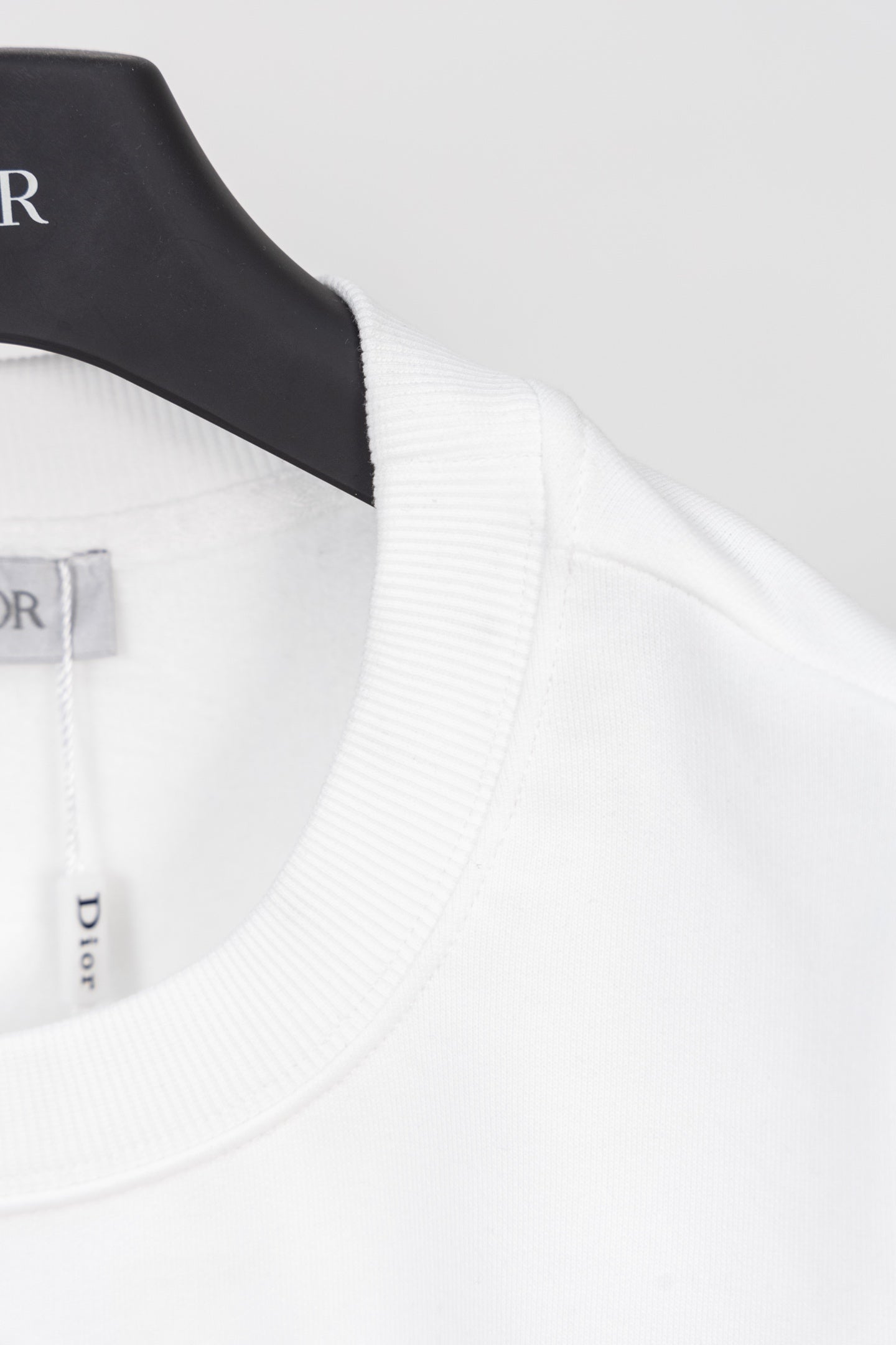 White sweatshirt neckline and shoulder seam with ribbed collar trim