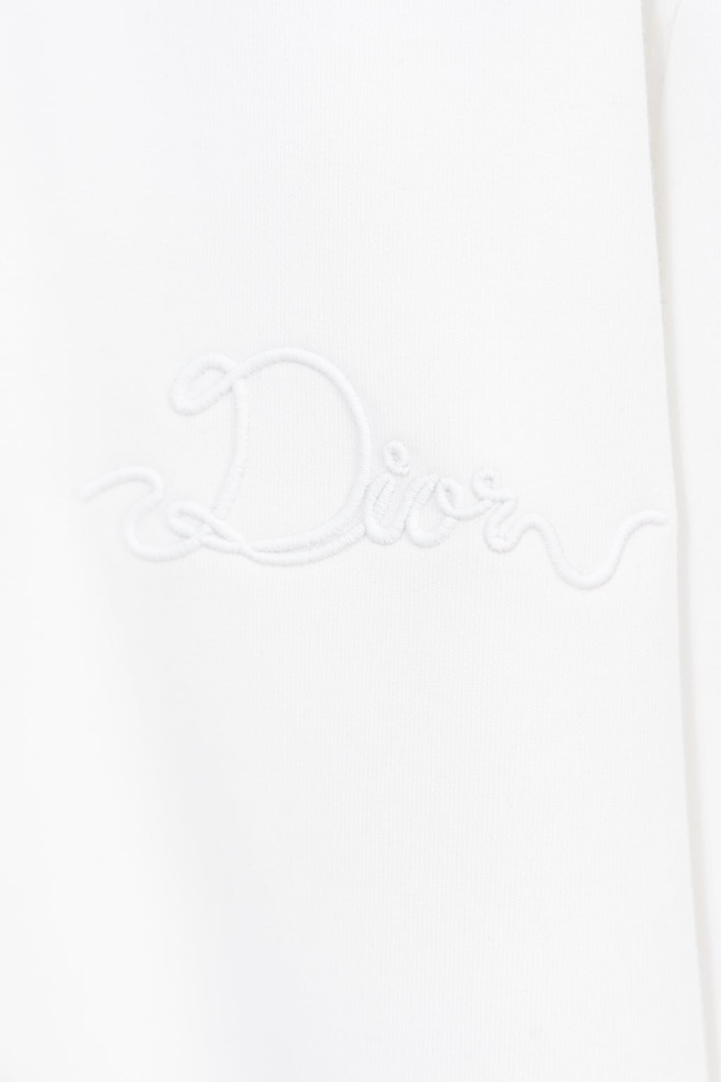 White sweatshirt with raised Dior signature-style embroidery on the front