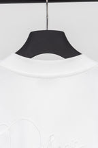 White sweatshirt neckline with ribbed collar, hanging on a dark hanger
