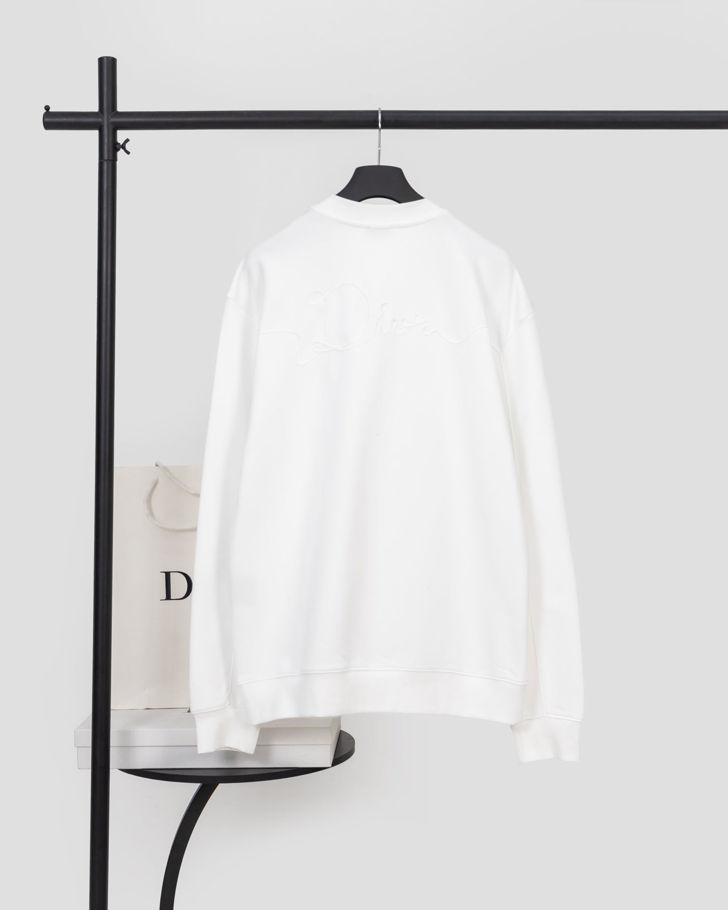 White long-sleeve sweatshirt back view with ribbed cuffs and hem