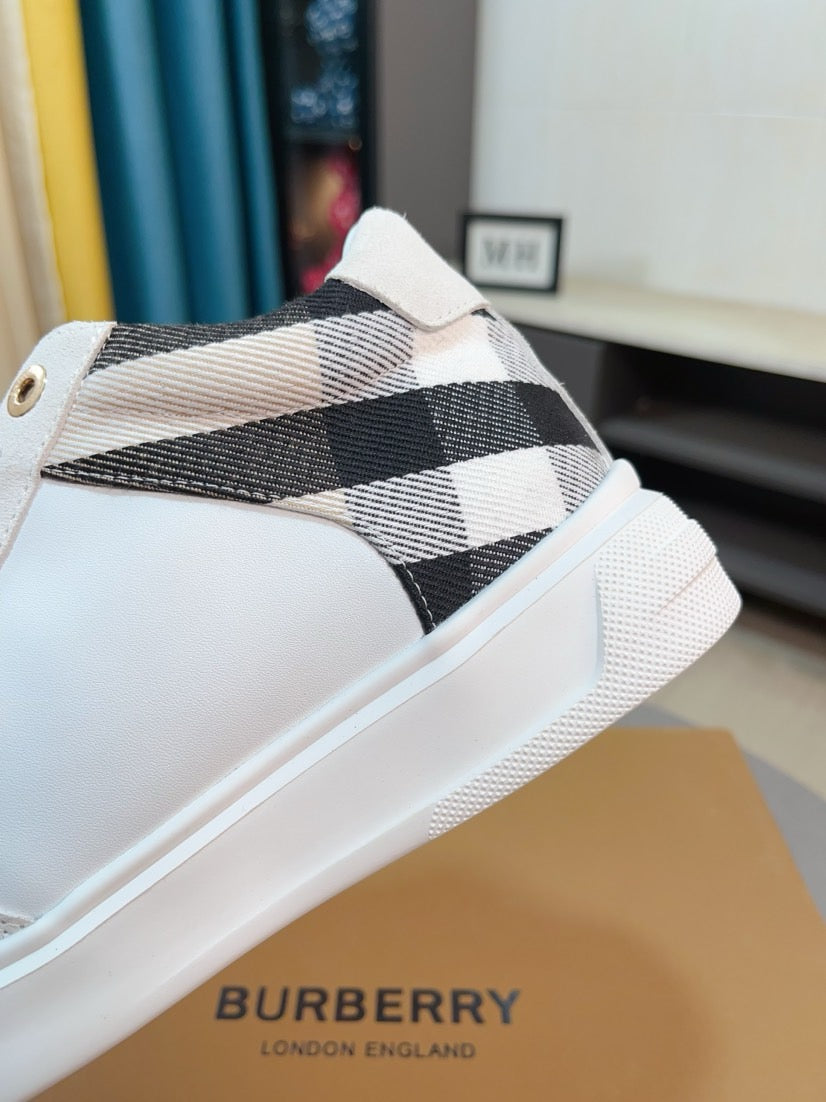 White sneaker with black-and-white plaid strap detail
