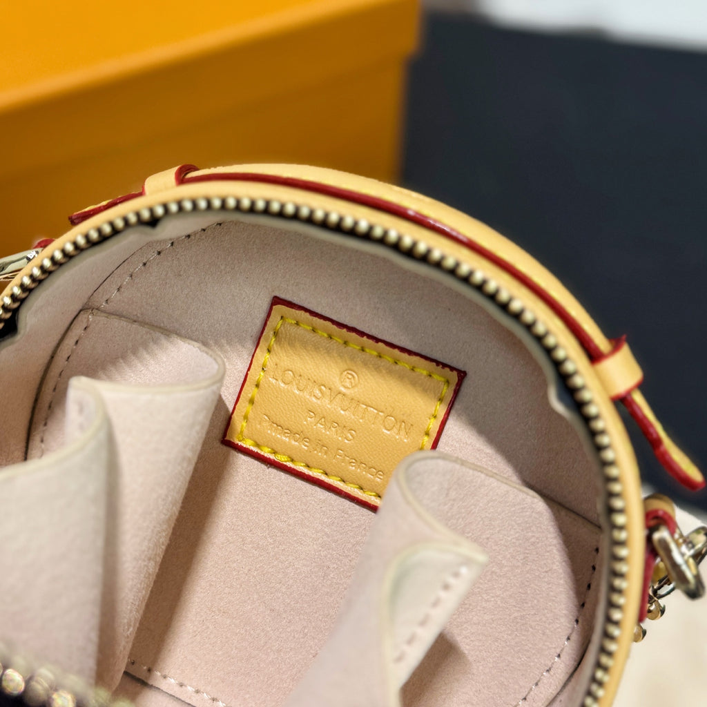 Monogram mini bag interior with white lining and tan Louis Vuitton leather patch
