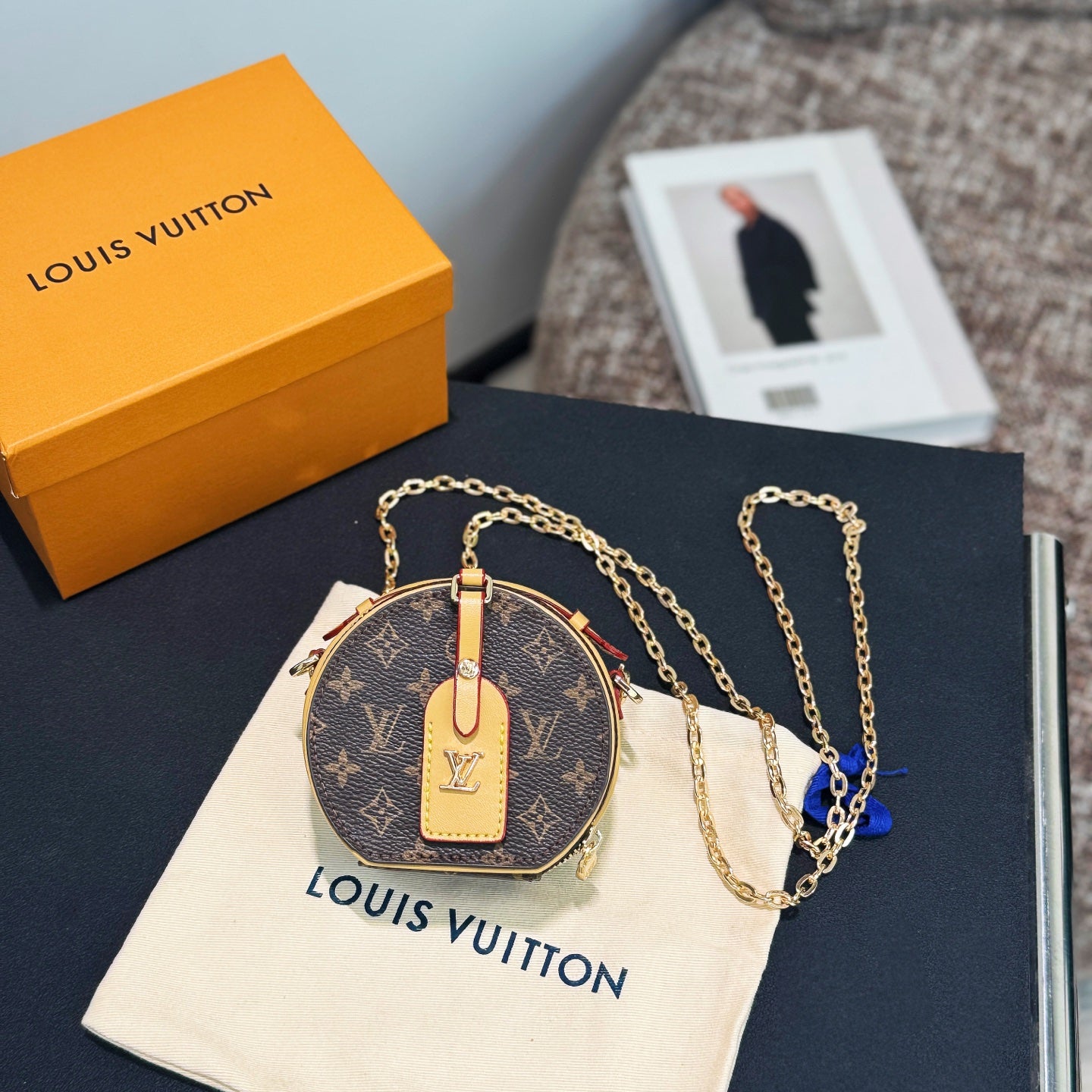 Louis Vuitton round monogram crossbody bag with tan leather strap and gold chain