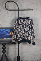 Dior knit cardigan in navy and cream with allover logo pattern and button front.