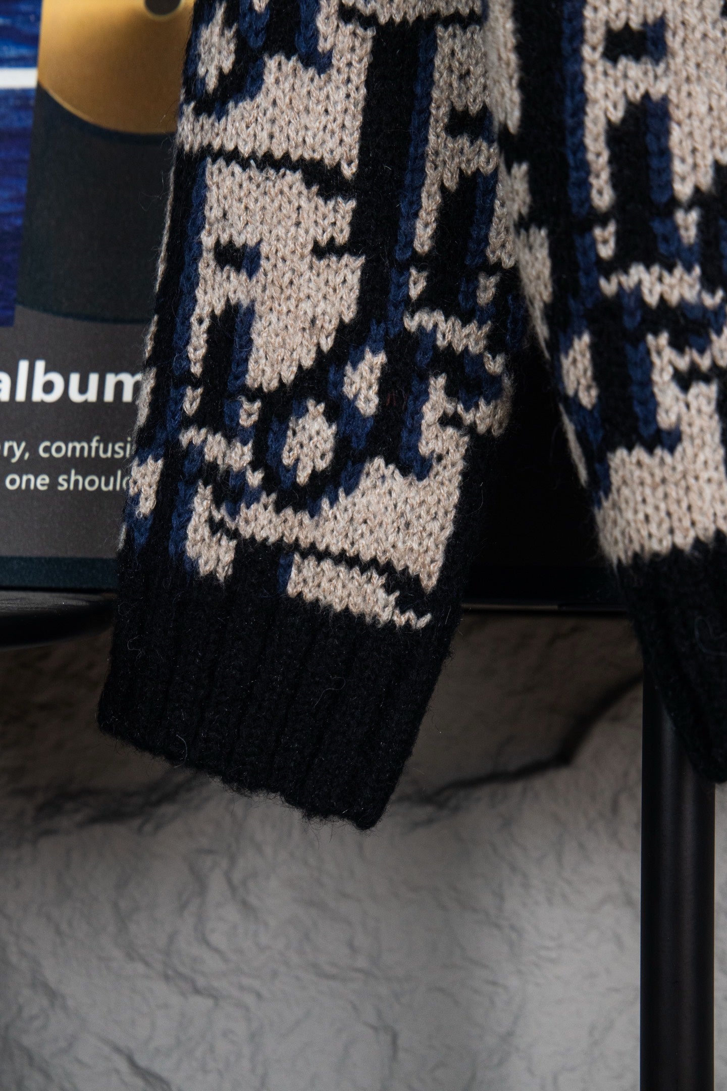 Dior knit cardigan sleeve and hem in navy and cream geometric logo pattern.