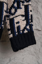 Dior knit cardigan lower half with navy and cream repeating logo-style pattern.